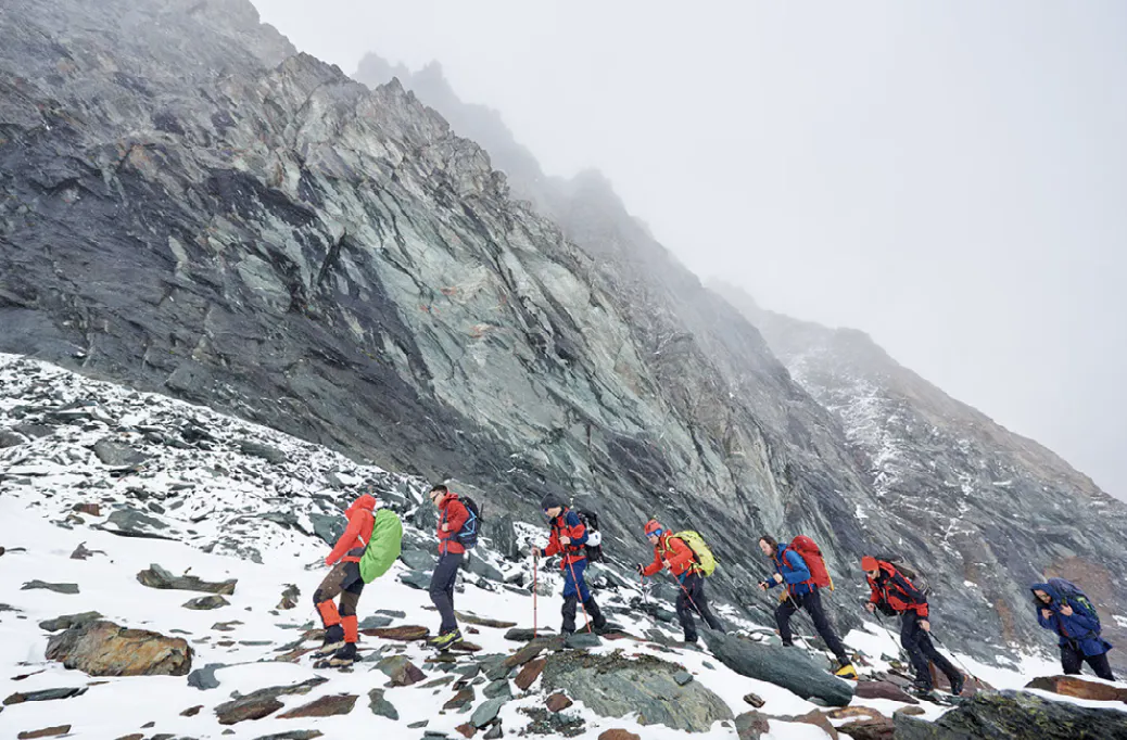 Group of trekkers with day packs in the glacial wilderness