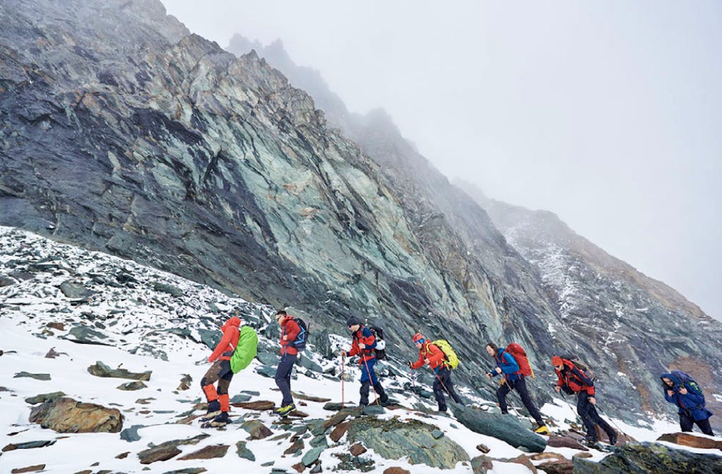 Group of trekkers with day packs in the glacial wilderness 