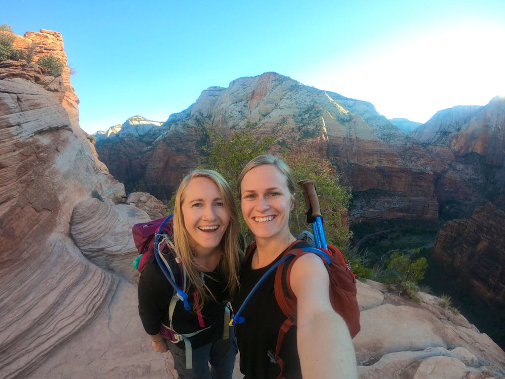 two travelers enjoying the Navajo sandstone at Zion National Park in Angel's Landing