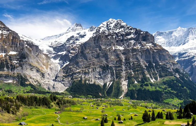 Hikers in a village to village trail adventure in the Alps in Europe