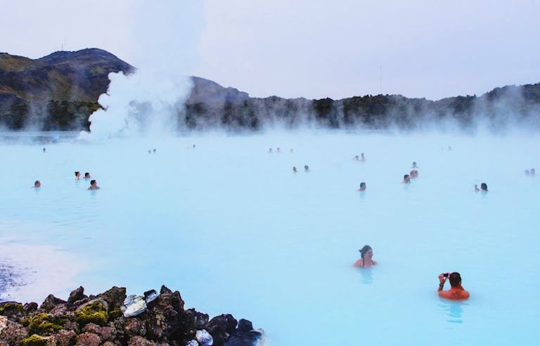 Tourists and local people soaking in the blue lagoon in Iceland in Europe