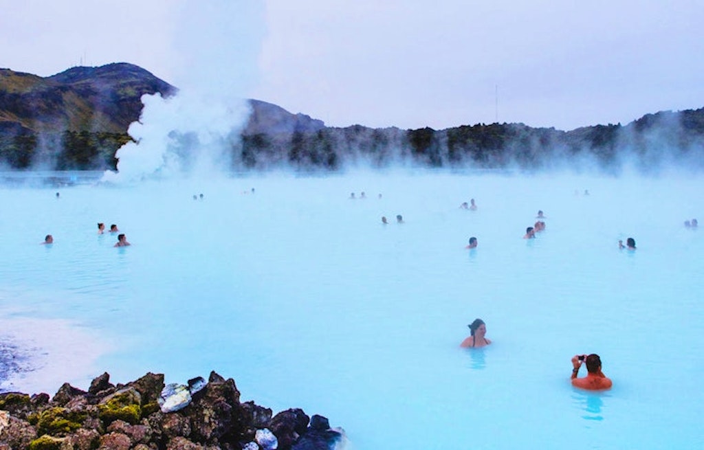 Tourists and local people soaking in the blue lagoon in Iceland in Europe