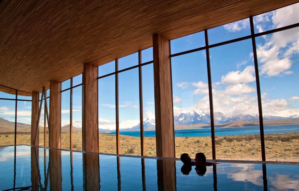 A couple looking at each other earnestly in the indoor pool in Tierra Patagonia Hotel & Spa in Torres del Paine National Park in Chile