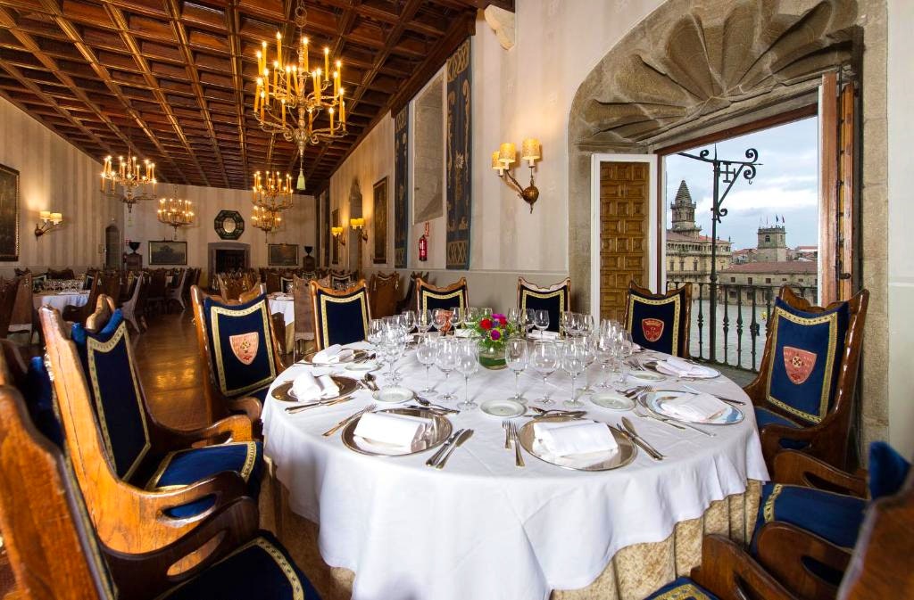 Old rich decorations in a golden adorned dining room in Parador de Santiago de Compostela, Spain's oldest hotel