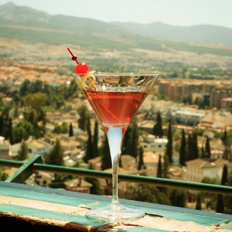 Sipping a cocktail at the rooftop bar in Alhambra Palace