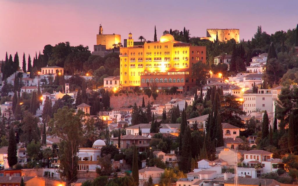 A scenic night view of Alhambra Palace in Granada - that is stylish and Moroccan-inspired