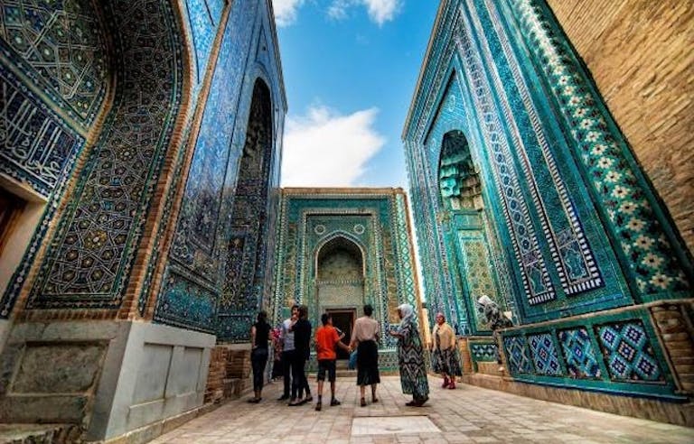 group of tourists exploring the UNESCO-designated mosque in Uzbekistan near the Silk Road in the Middle East