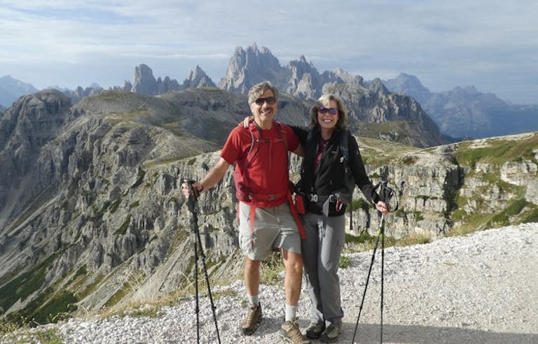two female and male hikers with trekking poles in the Dolomites in the Alps in Europe