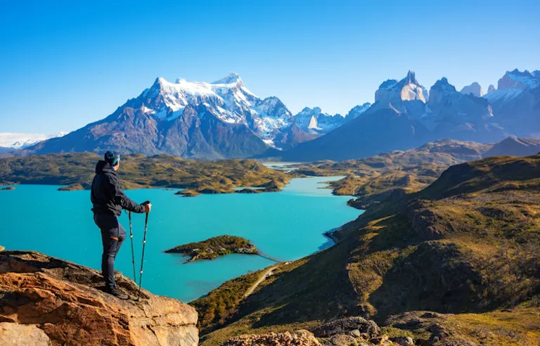 Solo male hiker on a hiking trail in
Torres del Paine with a view of Los Glaciares in Chile, Patagonia region, in Central America