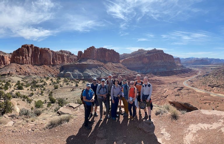 Group of trekkers hiking near the Colorado River in Canyon Lands National Park