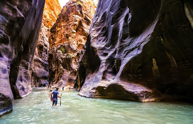 Hiker traveling in the Narrows in southwestern Utah at Zion National Park 