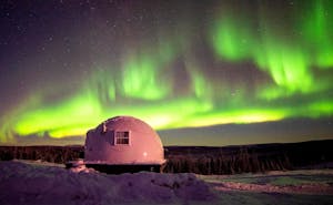 Experience the magical beauty of the Aurora borealis as it dances gracefully over a dome surrounded by a pristine blanket of snow. This custom travel adventure provides the perfect opportunity to witness this breathtaking natural phenomenon in all