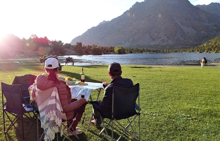 Hikers comfortably camping on a trail in Tajikistann Fann Mountains