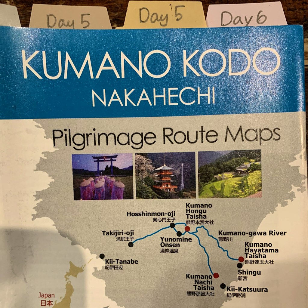 Local Guide Showing Travelers a Map of the Kumano Kodo Pilgrimage Route 