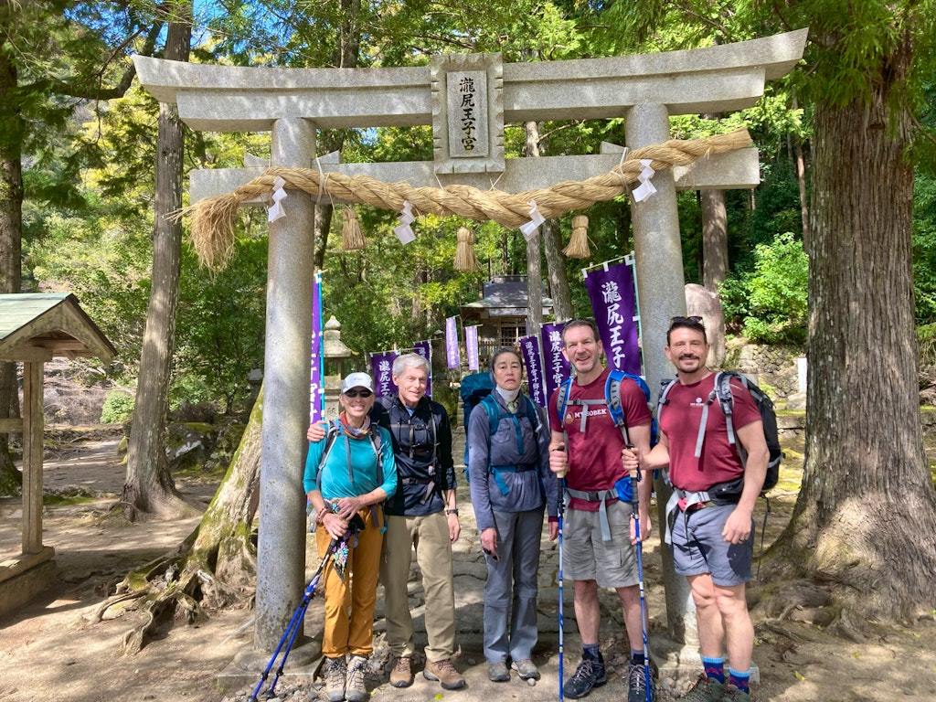 Group of travelers stopping at one of the five major Oji shrines on the Kumano Kodo route in Japan