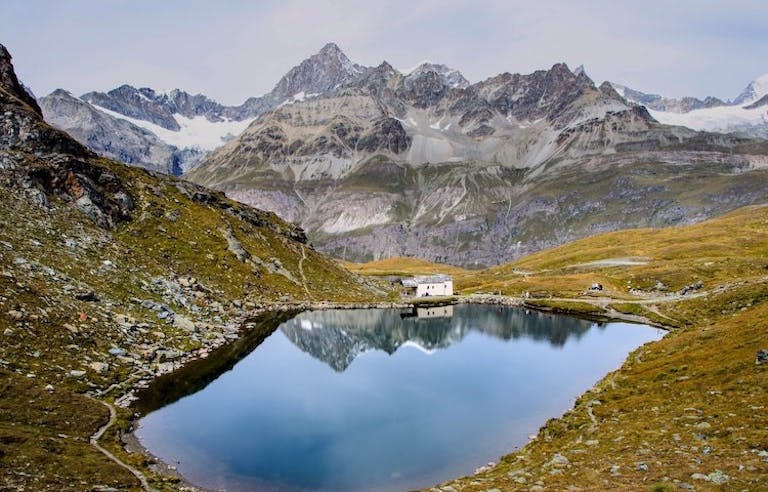 Hike along serene mountain lakes on the Haute Route in the Alps Region in Switzerland, Europe