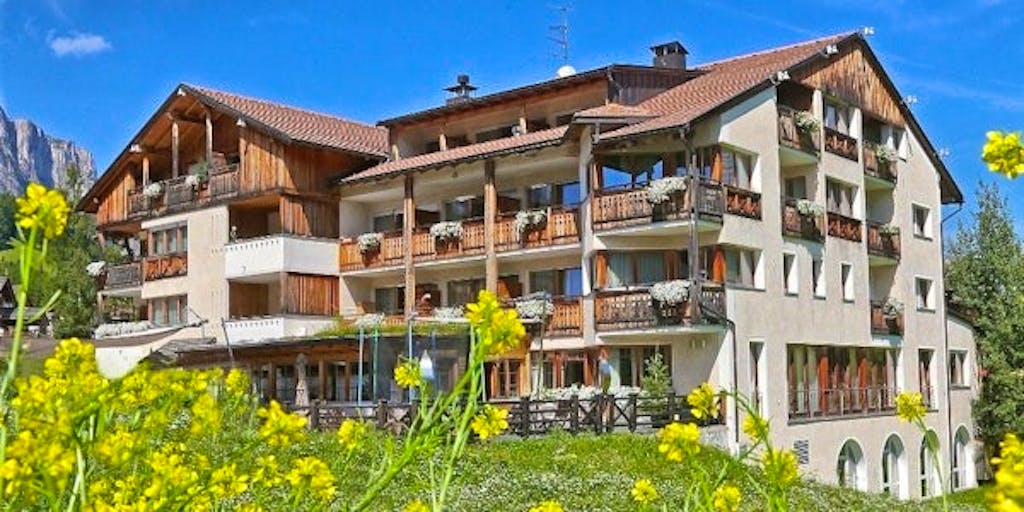 Aerial view of Hotel La Majun in Mamolada with sweeping views of the Dolomites - perfect for an overnight stay!