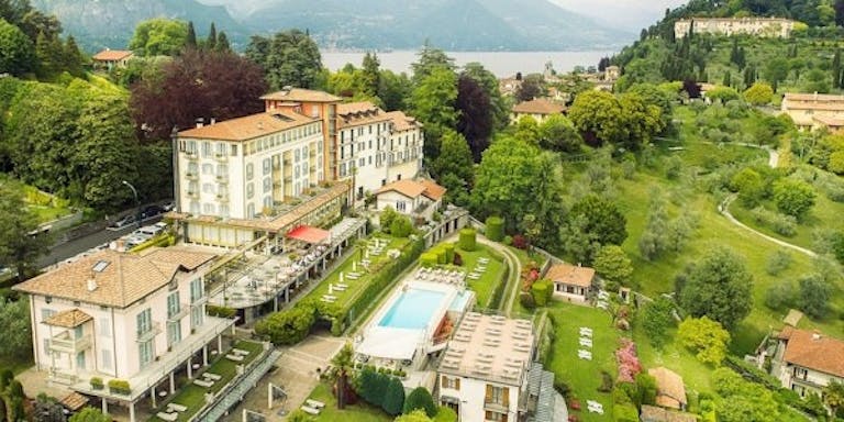 Aerial view of Hotel Belvedere on a hill overlooking Locarno and Lake Maggiore in Locarno near the Alps