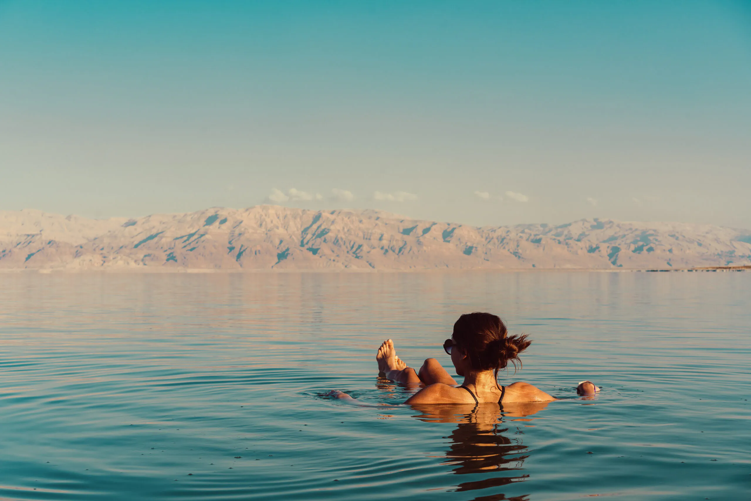 Woman is floating in the Dead Sea in Israel during her stay