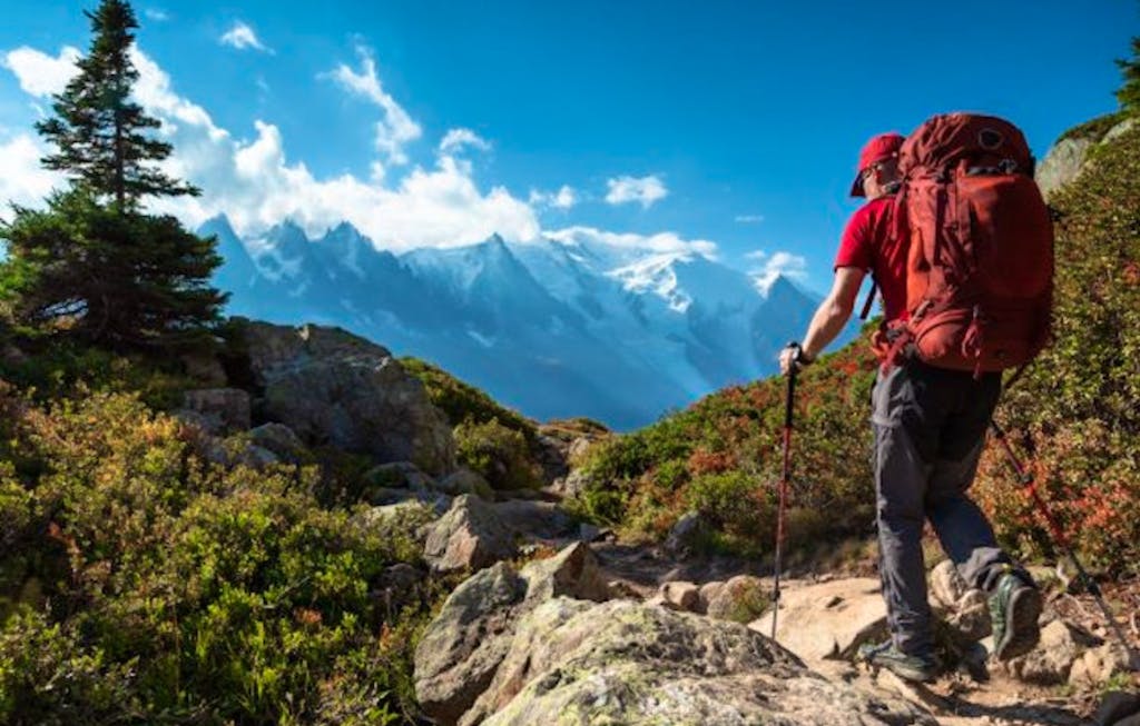 Hiker trekking on a off the beaten path trail near the Mont Blanc