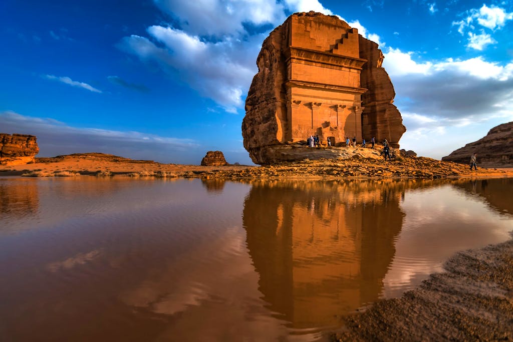 Tourists exploring the madain saleh or al hijr which is an archaeological site located in alula in saudi arabia