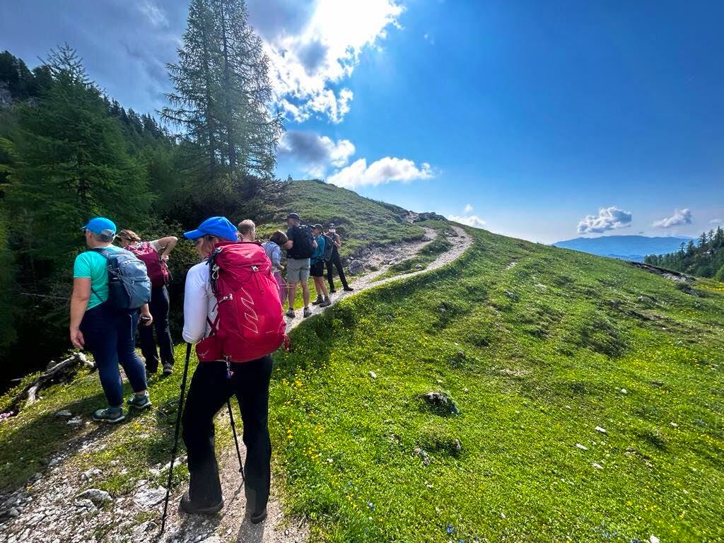 Group of hikers trekking in the valley of Sevewn Triglav Lakes during their Slovenia hiking adventure
