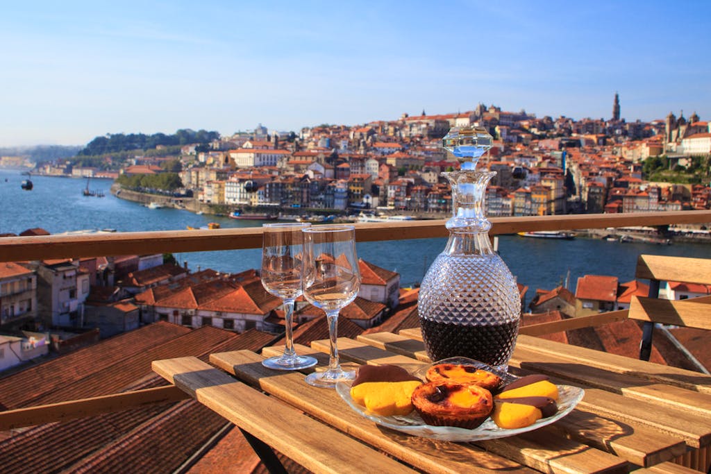 A wooden table on a balcony in Oporto, Portugal's foodie capital during a guided tour