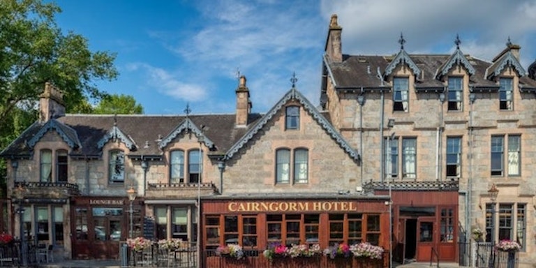 Tourists who are seeking an overnight stay at a local hotel checks out Cairngorm Hotel in Aviemore, Scotland