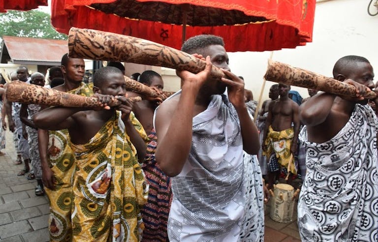 Tourists watching a traditional dance in a local village in Ghana