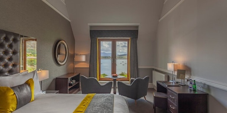Tourists who are seeking an overnight stay at a local hotel checks out Cuillin Hills Hotel in Portree-Skye, Scotland