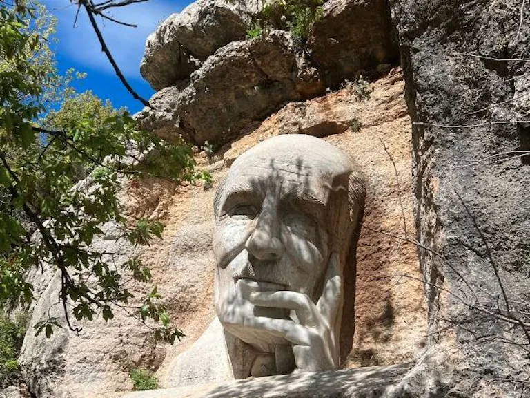 Tourists look at the historic statue of Lebanese poet Mikhail Naimy in the Baskinta Literary Trail