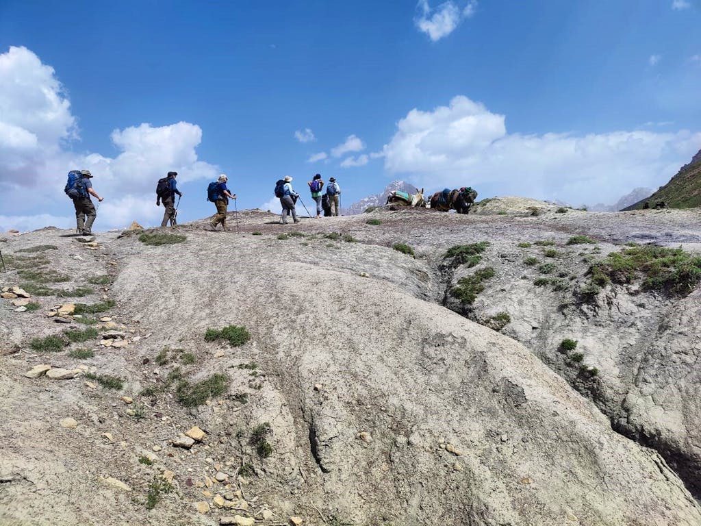 Group of hikers trekking the great Alauddin Pass in Tajikistann Fann Mountains