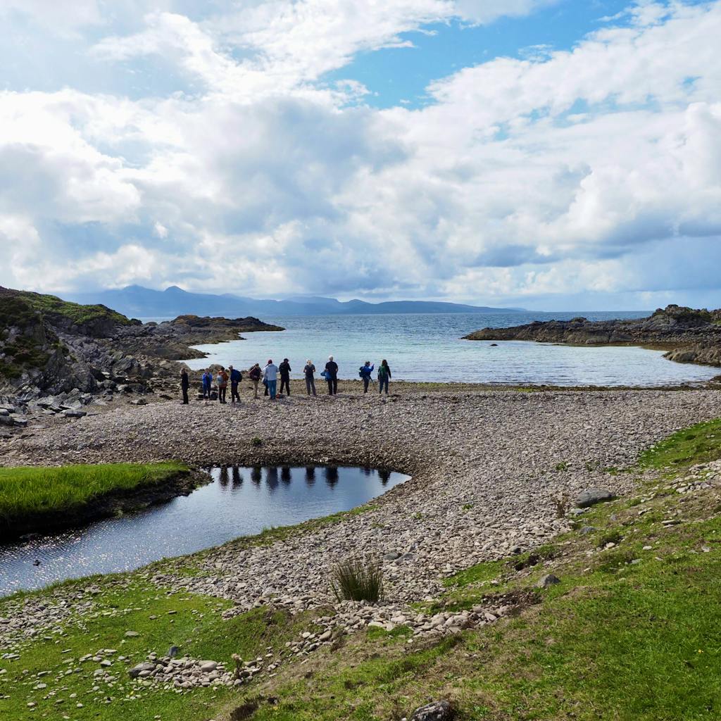 Tourists hiking the Isle of Barra, one of the Scottish Islands in Europe