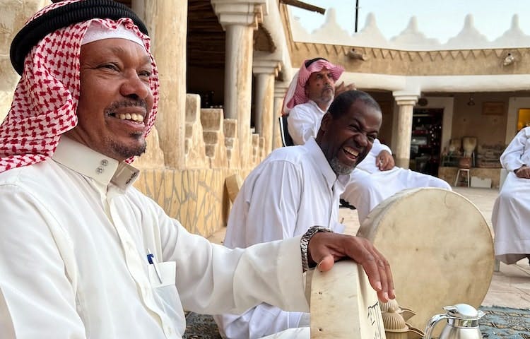 Traditional adorned men laughing in the local street in Saudi Arabia