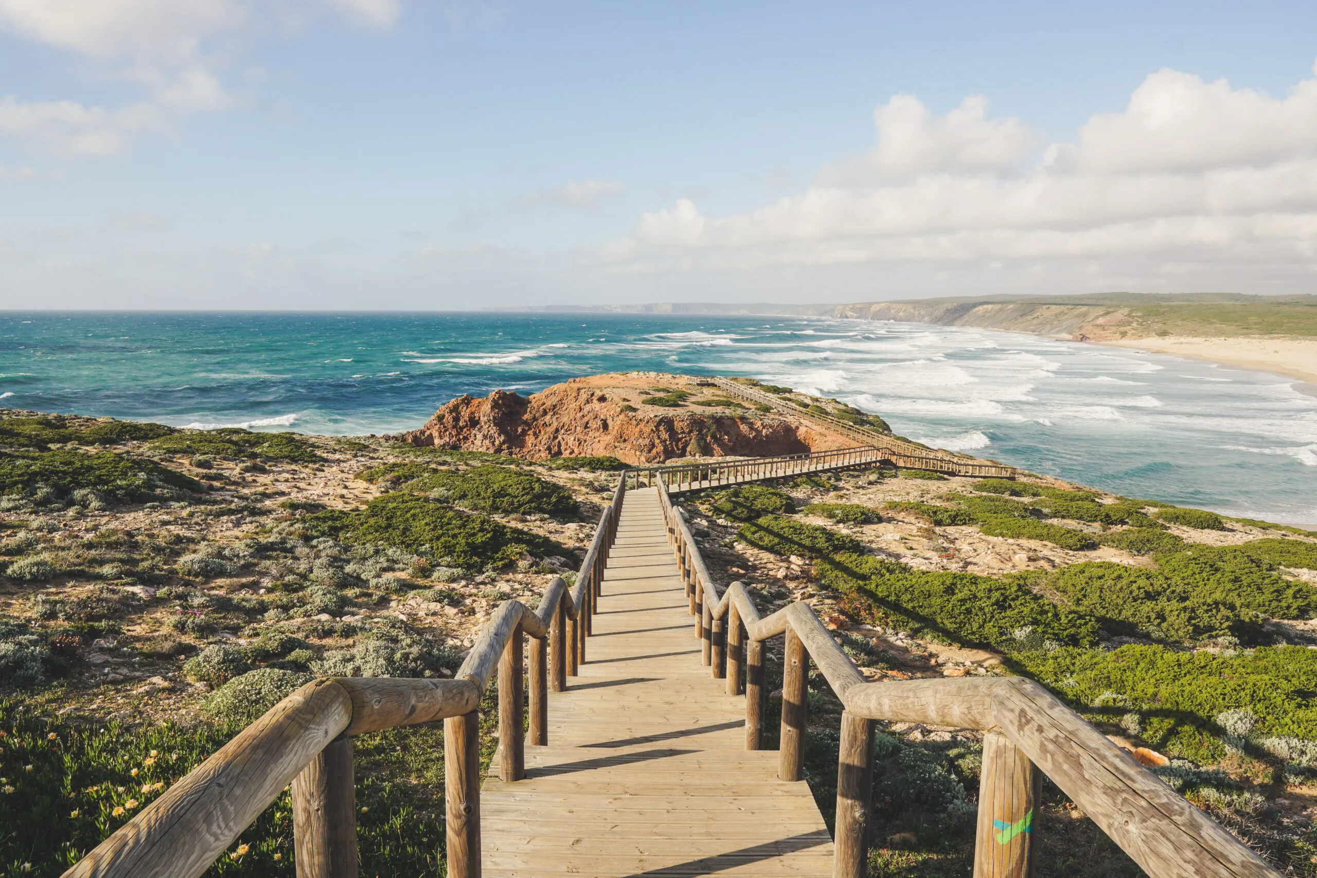 Tourists walking along coastline in Algarve region
