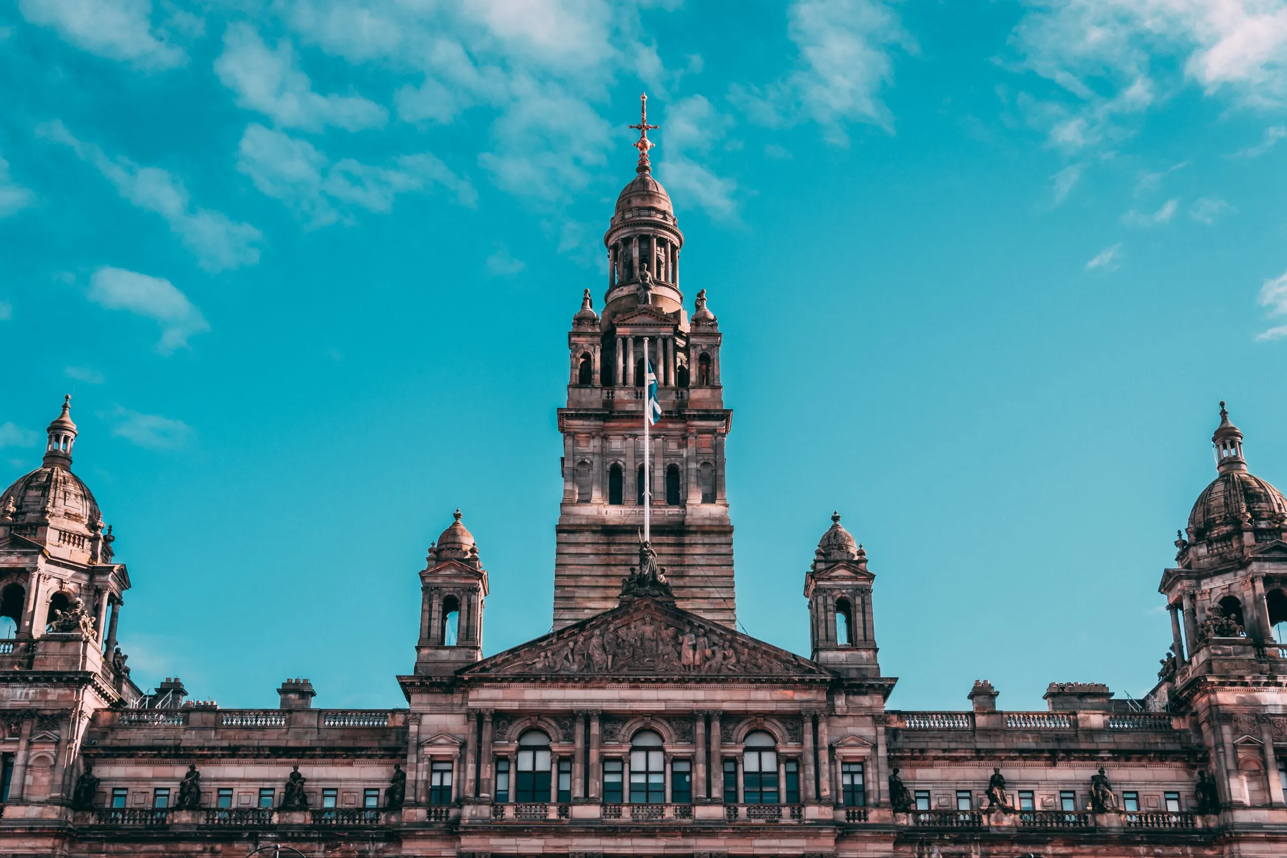 Tourists exploring popular landmarks in Glasgow, which is a popular destination in Scotland, Europe