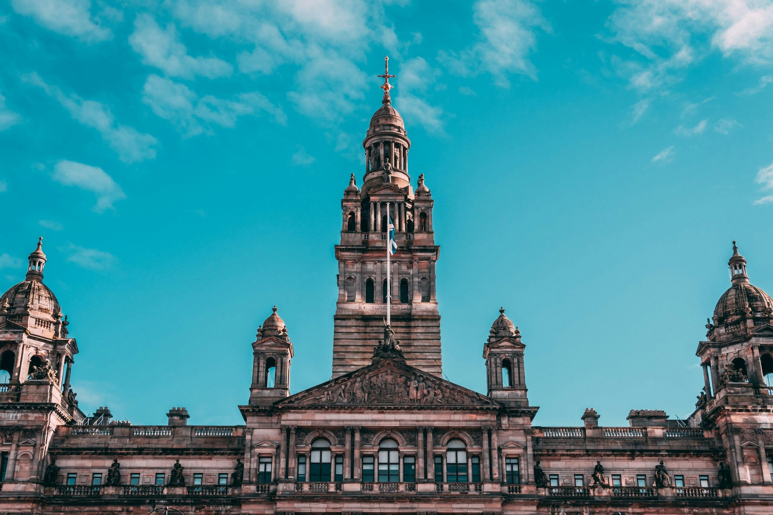 Tourists exploring popular landmarks in Glasgow, which is a popular destination in Scotland, Europe