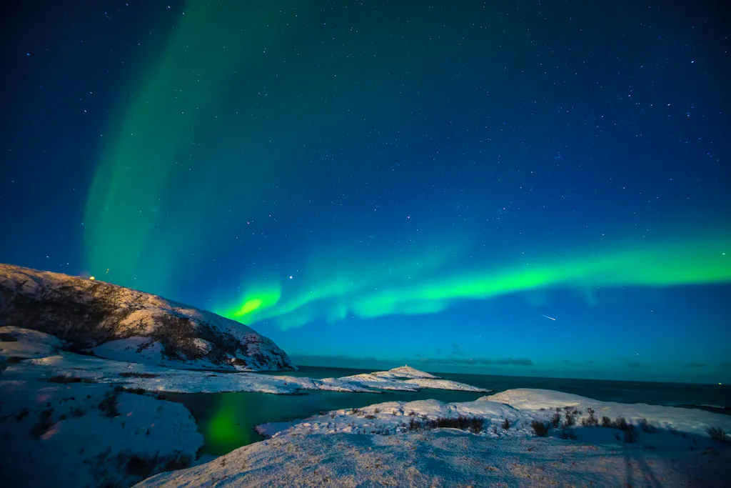 Breathtaking capture of the beautiful Aurora Borealis at Tromso, Norway. And with heavens help, manage to capture a streaking shooting star across the starry skies.