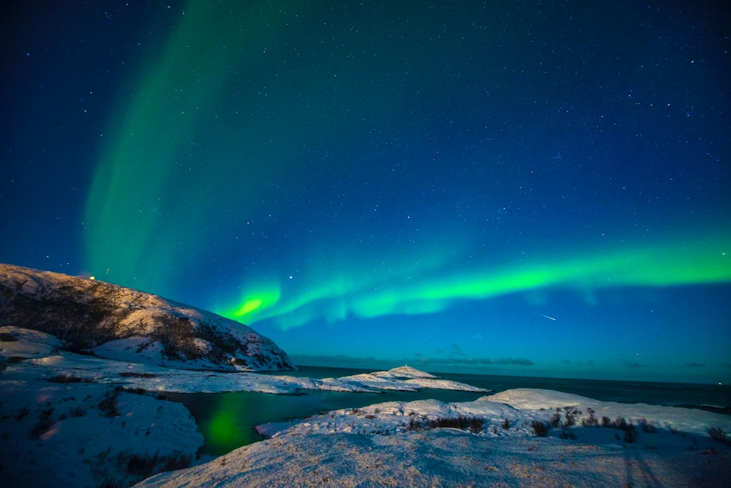 Breathtaking capture of the beautiful Aurora Borealis at Tromso, Norway. And with heavens help, manage to capture a streaking shooting star across the starry skies.

