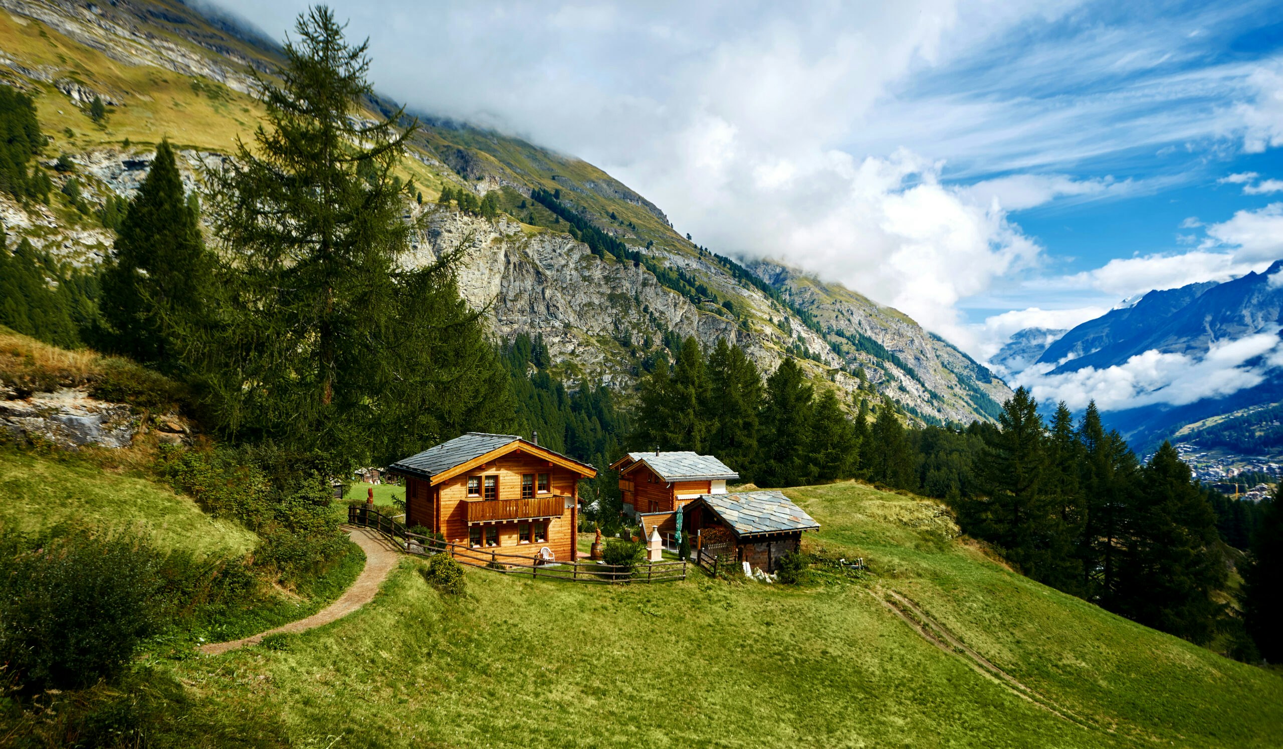 A green grassy hillside in an alps village to village tour in Switzerland, Europe in the Alps mountain region