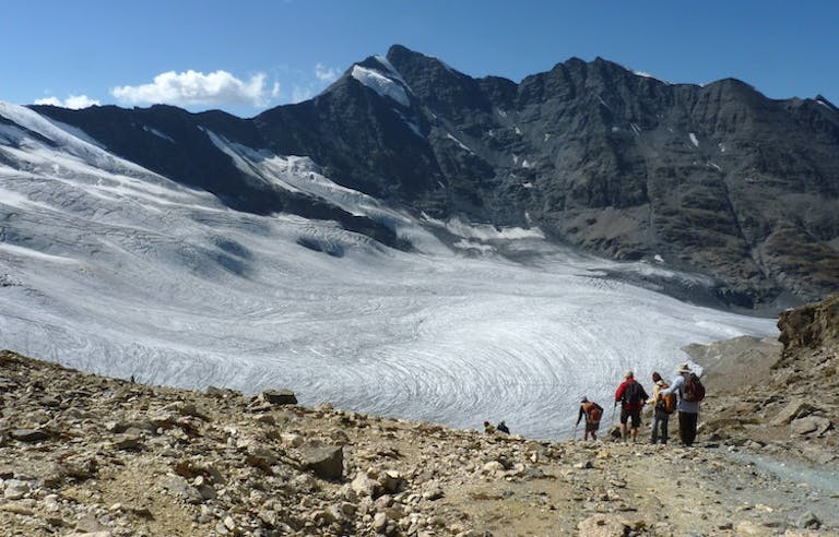 Group of trekkers going on a challenging hike to the heart of Gran Paradiso National Park in the Graian Alps in Italy, Europe