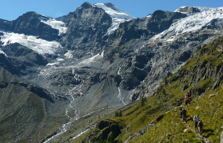 Group of experienced hikers on a challenging trek in Graian Alps in Italy, Europe
