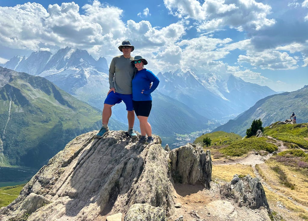 Couple in hiking gear trekking the Mont Blanc in nice alpine weather in Europe