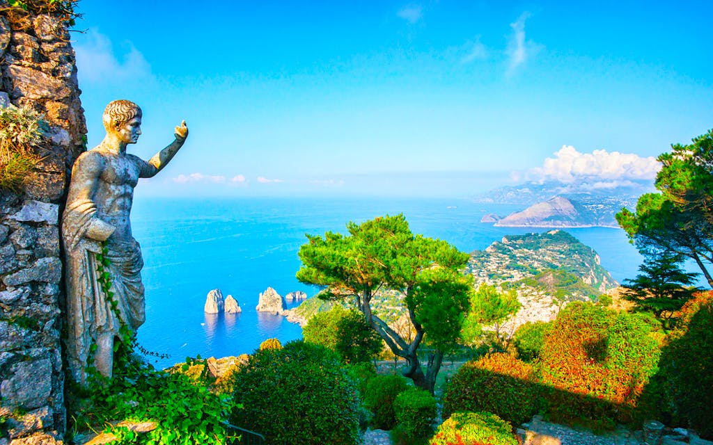 Statue at garden on Capri Town in Italy, Europe with Amalfi coastline as backdrop