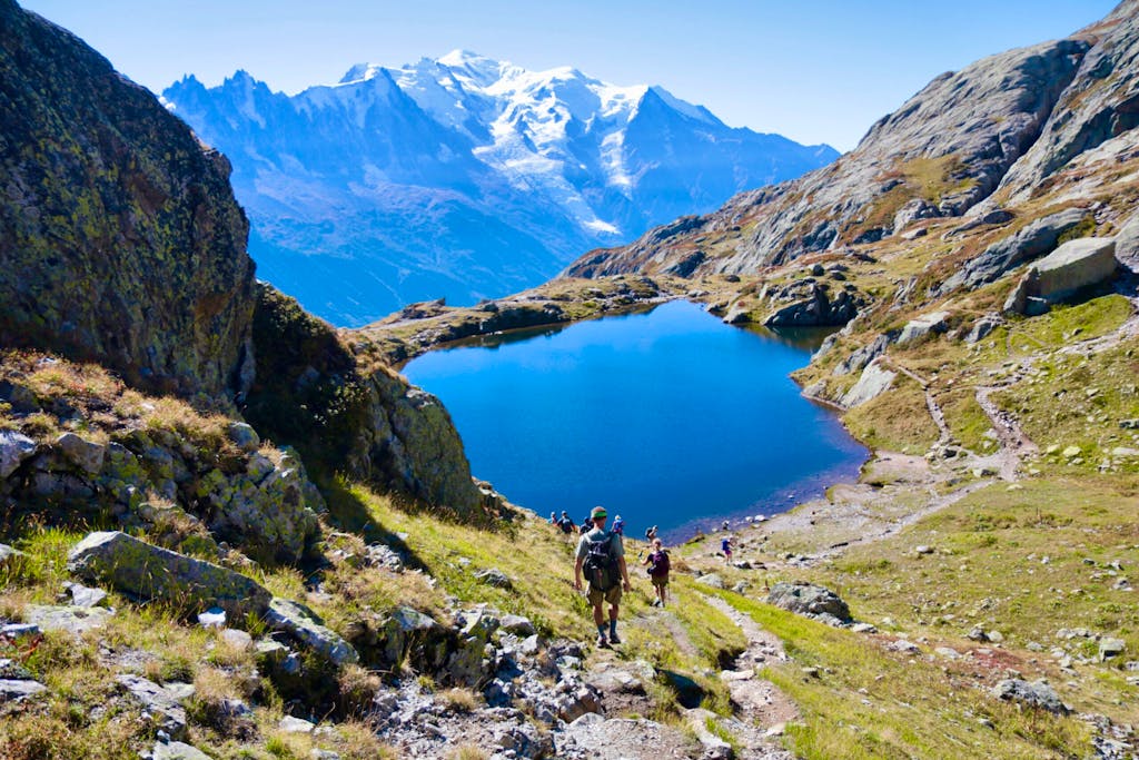 Group of hikers on an epic bucket-list classic multicountry loop on a hiking adventure in the Mont Blanc mountains in Europe