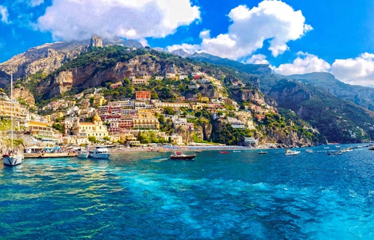 Big and small fishing boats floating on the Sorrento Peninsula facing the Amalfi Coast in Italy, Europe
