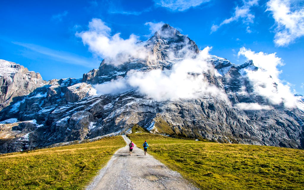 Two runners on the pass way to Grosse Scheidegg above Grindelwald, Switzerland