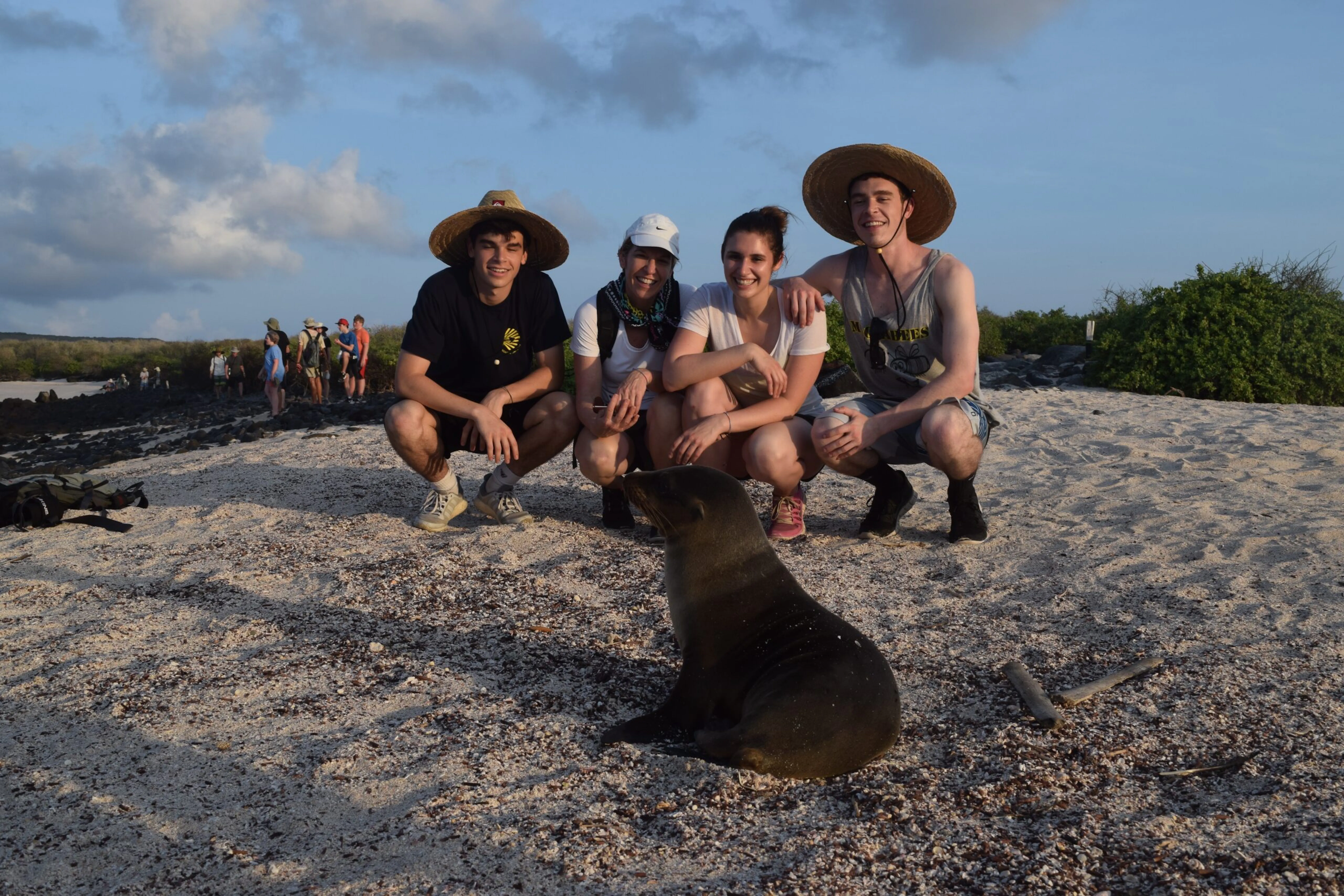 A group of people posing for a photo with a sea lion.