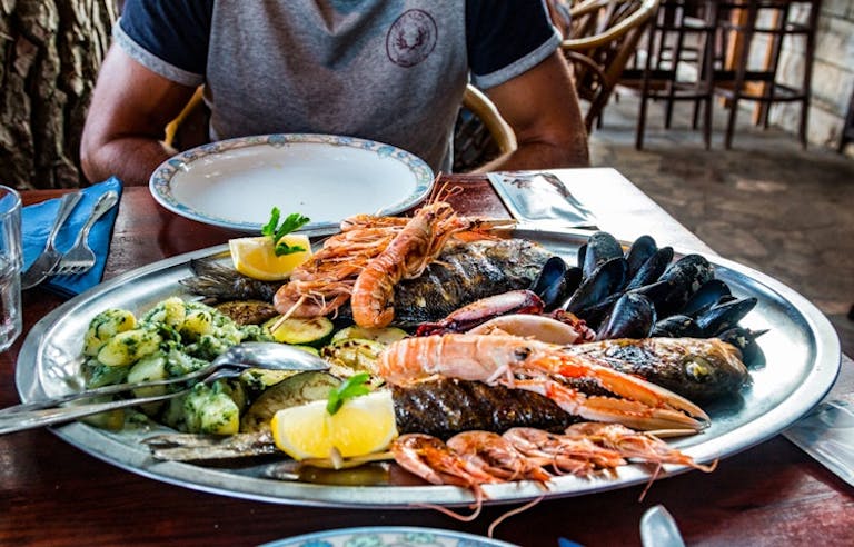 Man is enjoying regional delicacies in the Mediterranean