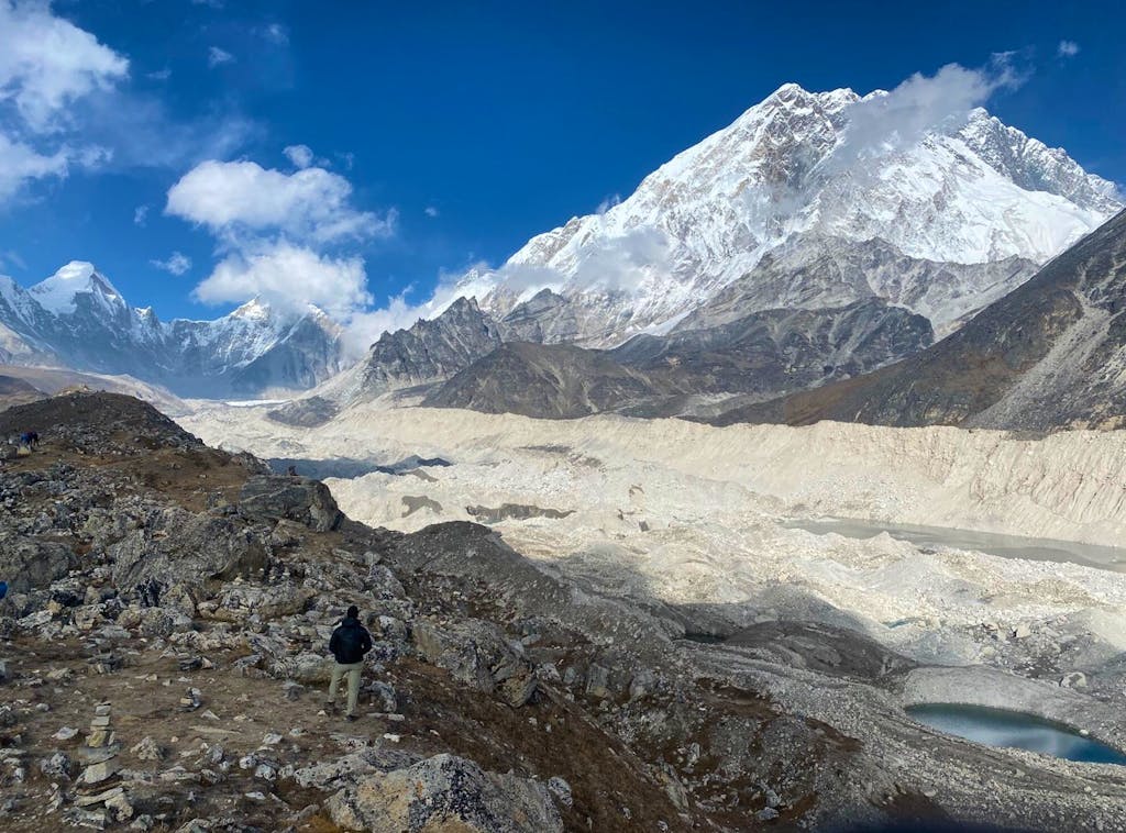 group of hikers on a himalayan hiking trail adventure stops at Khumbu Glacier